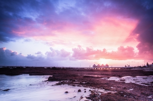 Distant view of Busselton at sunrise with sun rays shining through - Australian Stock Image