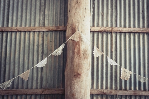 doily bunting in a rustic tin shed - Australian Stock Image