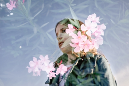 Double exposure of a young girl and flowers - Australian Stock Image