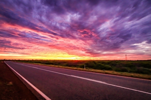 Dramatic sunrise over outback road - Australian Stock Image