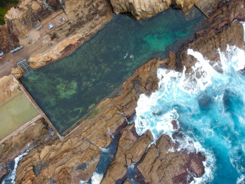 Drone image of ocean pool with swimmers in New South Wales - Australian Stock Image