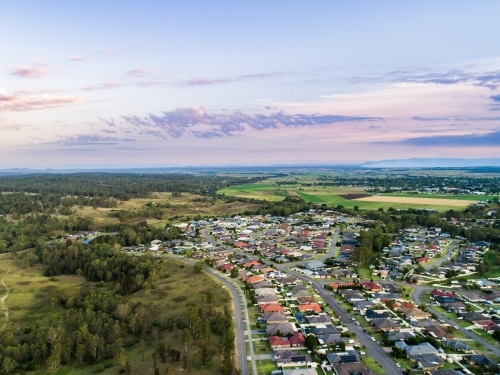Drone view over edge of suburbia to countryside edge of urban development - Australian Stock Image