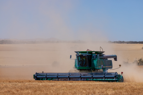 Dry-land farming machinery harvesting crop - Australian Stock Image