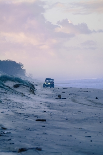 Dune buggies on South Stradbroke Island at dusk - Australian Stock Image