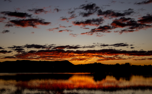 Dusk skies reflected in dam water - Australian Stock Image
