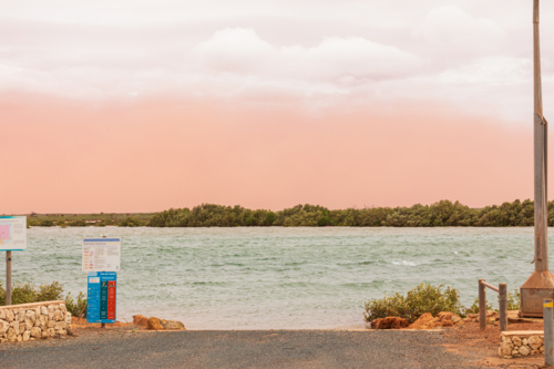 Dust storm at 4 Mile Creek, Onslow at the start of Cyclone Sean - Australian Stock Image