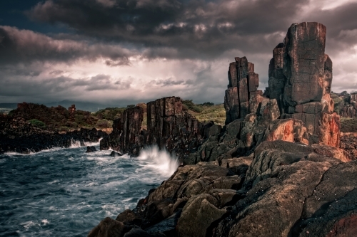 Eerie beauty of the tall imposing Bombo basalt columns