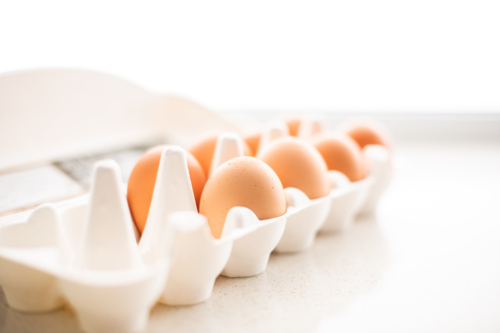 egg carton sitting in a white kitchen - Australian Stock Image