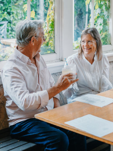 Elderly couple enjoying lunch together at cafe - Australian Stock Image