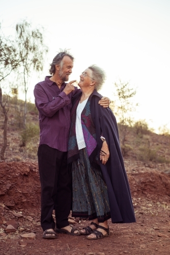 Elderly couple holding hands