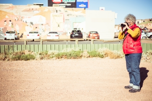 Elderly woman taking photos in the Northern Territory