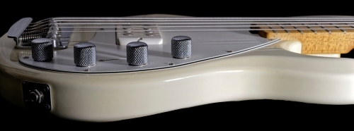 Electric Bass Guitar cream and silver side profile - Australian Stock Image