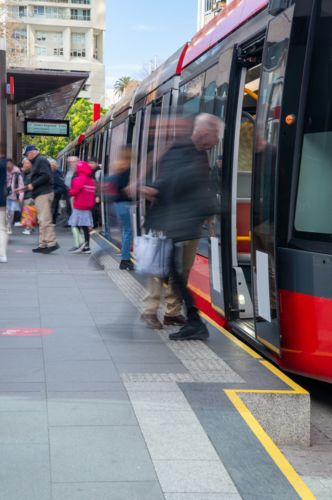 Embarking and disembarking light rail public transport in Sydney - Australian Stock Image