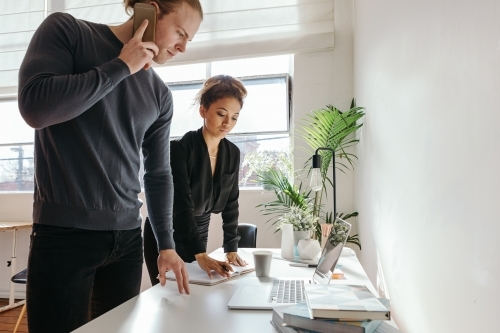 Employees calling for help with a technical problem - Australian Stock Image