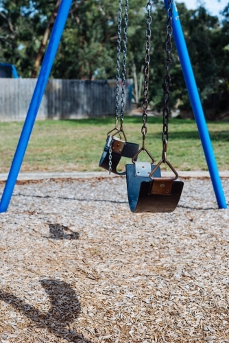 Empty chain swing in the playground in park - Australian Stock Image