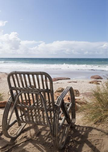 Empty chair overlooking the ocean - Australian Stock Image