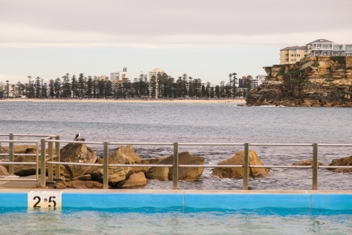 Empty ocean pool with urban and suburban background - Australian Stock Image