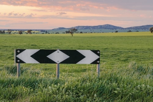 End of road warning sign on country road with small mountain range in background in Central Victoria - Australian Stock Image