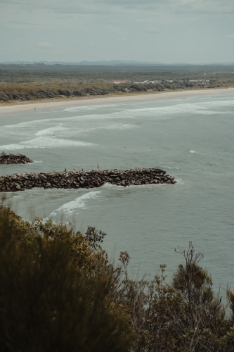 Evan's Head main beach and breakwall as seen from Razorback Lookout. - Australian Stock Image