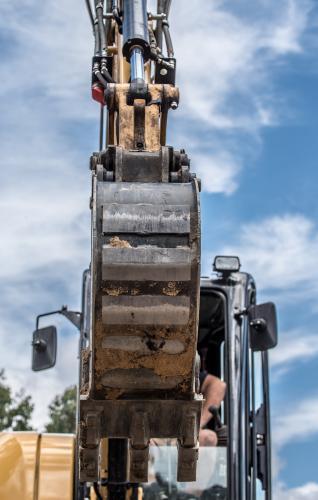 Excavator with cloudy sky - Australian Stock Image