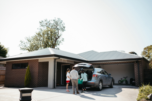 Family loading things into the car boot. - Australian Stock Image