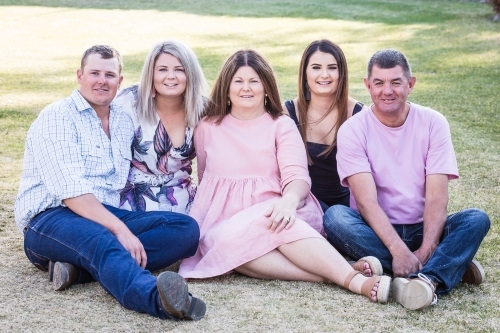 Family of five sitting together happy smiling - Australian Stock Image