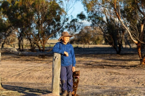 farm kid with his red kelpie dog - Australian Stock Image