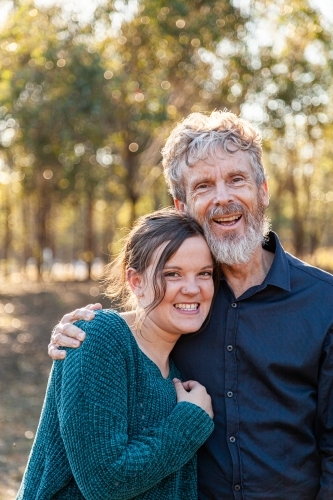 Father and adult daughter hug - Australian Stock Image