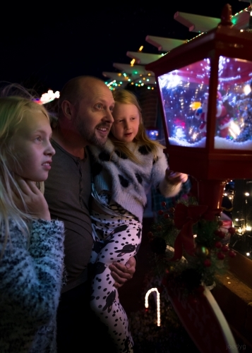 Father and Daughters Looking At Christmas Lights - Australian Stock Image