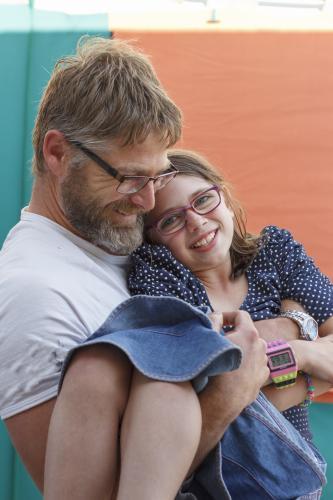 Father holding smiling daughter - Australian Stock Image