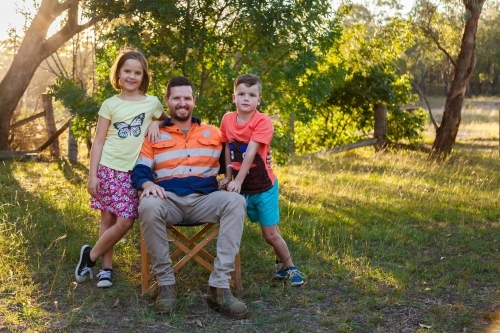 Father relaxing after work with his daughter and son - Australian Stock Image