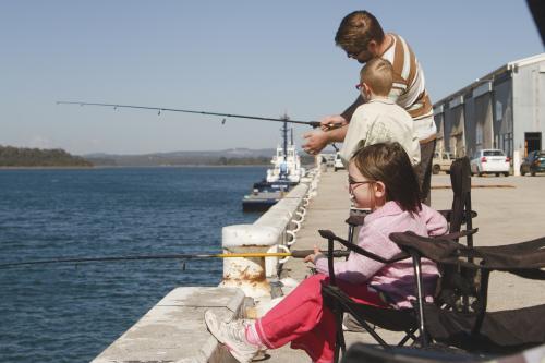 Father, Son and Daughter Fishing off wharf - Australian Stock Image