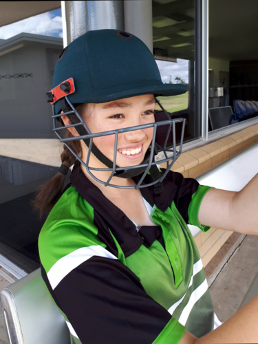 Female Cricket Player with helmet ready to play - Australian Stock Image