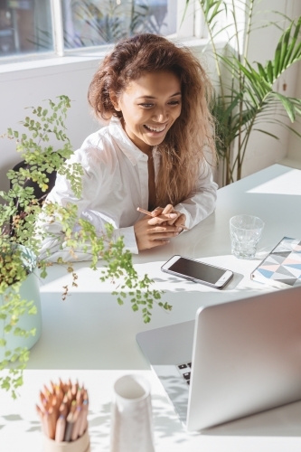 Female executive at a desk from above - Australian Stock Image