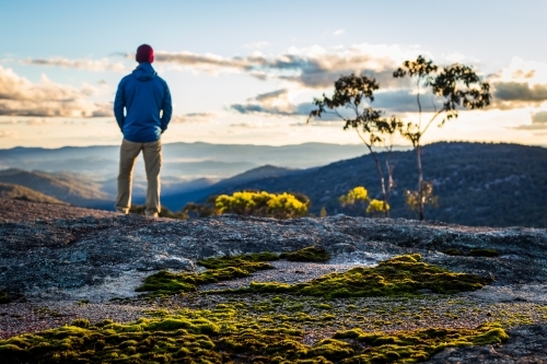 Figure overlooking mountain view - Australian Stock Image