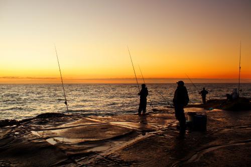 Fishermen on a rock platform - Australian Stock Image