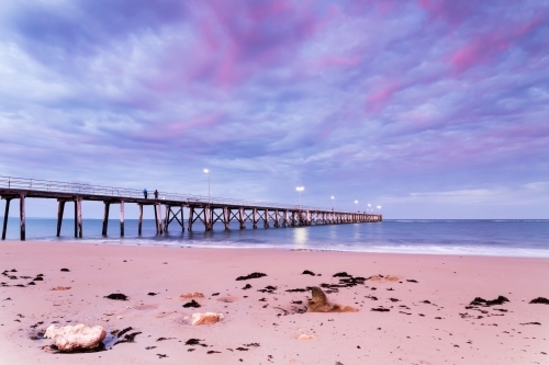 fishermen on jetty in early morning light - Australian Stock Image