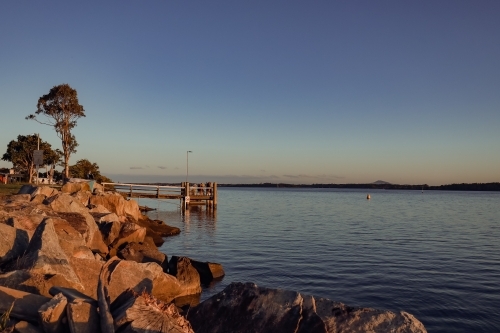 Fishing jetty on the Clarence River at sunset. Iluka New South Wales Australia - Australian Stock Image