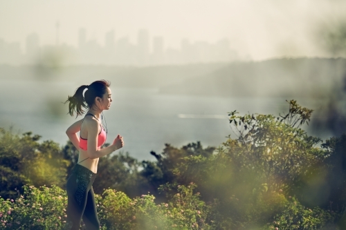 Fit Asian woman running for morning exercise