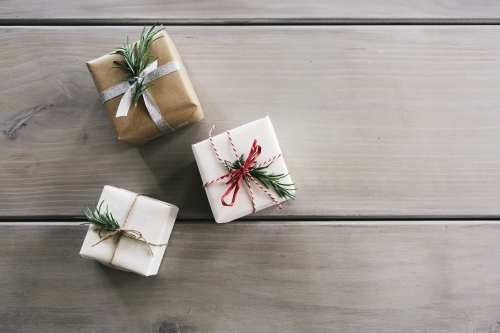 Flat lay of three Christmas gifts with stylish wrapping - Australian Stock Image
