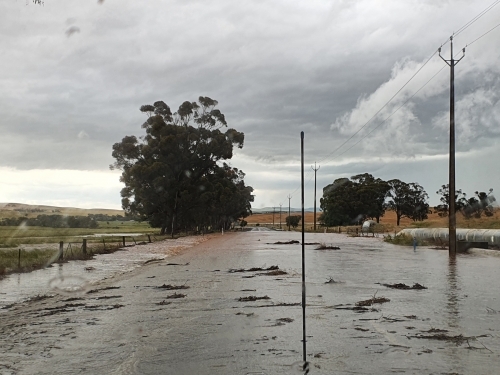 flooded road with debris - Australian Stock Image