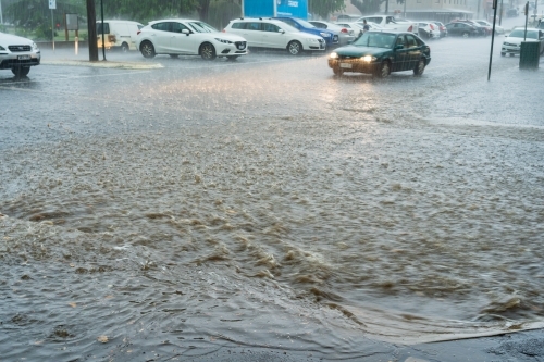 Flooding rain crossing a city street - Australian Stock Image