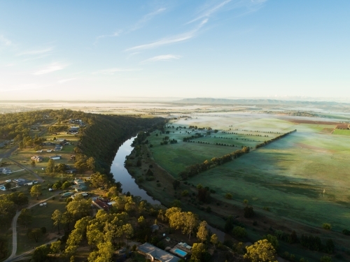 Fog lying over distant farm land and paddocks in early morning - Australian Stock Image