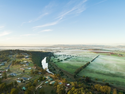 Fog lying over distant farm land and paddocks in early morning - Australian Stock Image