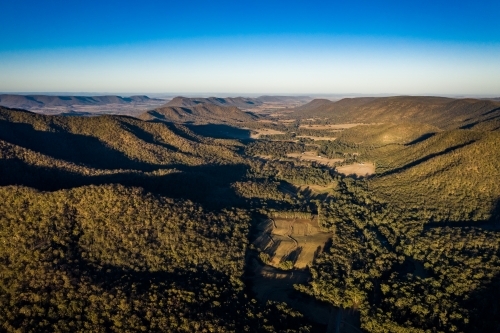 forest landscape with trees valley and creek - Australian Stock Image