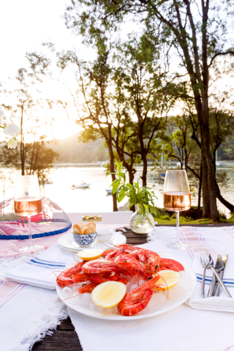 Fresh seafood on ice and rose with a water view - Australian Stock Image