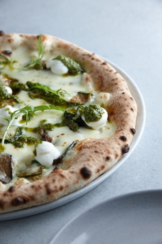 Fresh vegetarian pizza on plate - Australian Stock Image