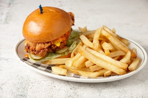 Fried chicken burger and chips - Australian Stock Image