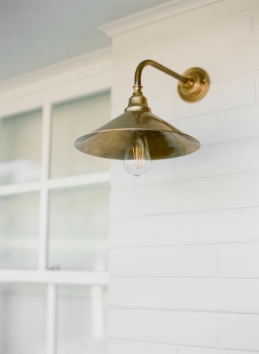 Front entry porch brass wall light - Australian Stock Image