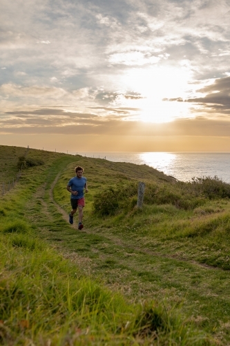 Full Length of Man in Distance Running Along Country Road - Australian Stock Image